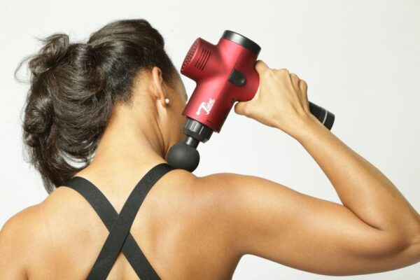 women doing massage with total massage gun