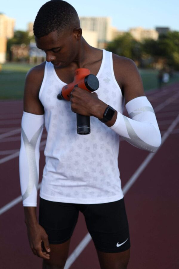 athlete doing massage with total massage gun