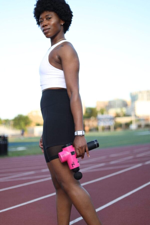 athlete women holding total massage gun