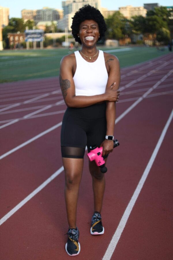 athlete women holding total massage gun