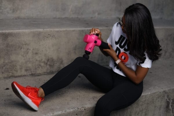women doing massage with total massage gun