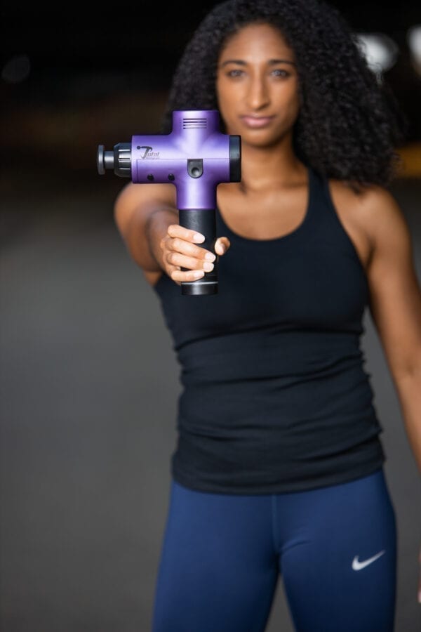 Model Holding Purple Massage Gun