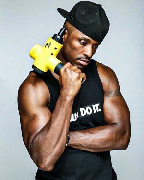 athlete holding total massage gun
