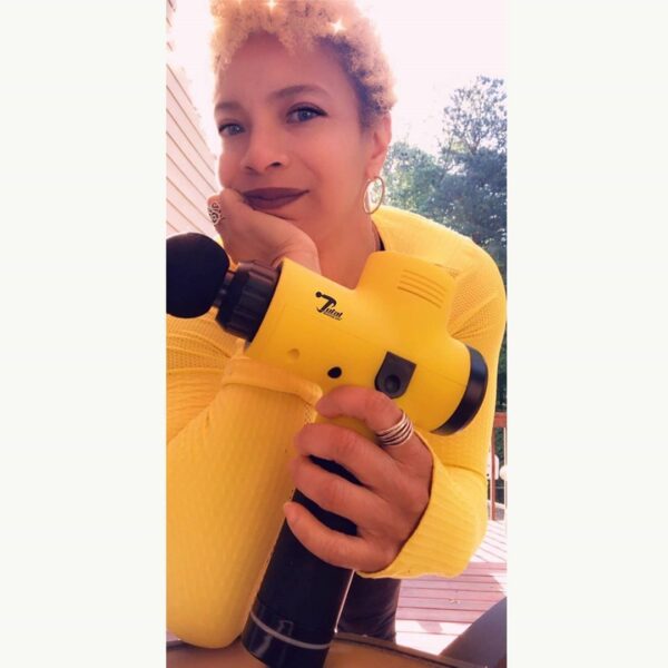 Athlete women holding total massage gun