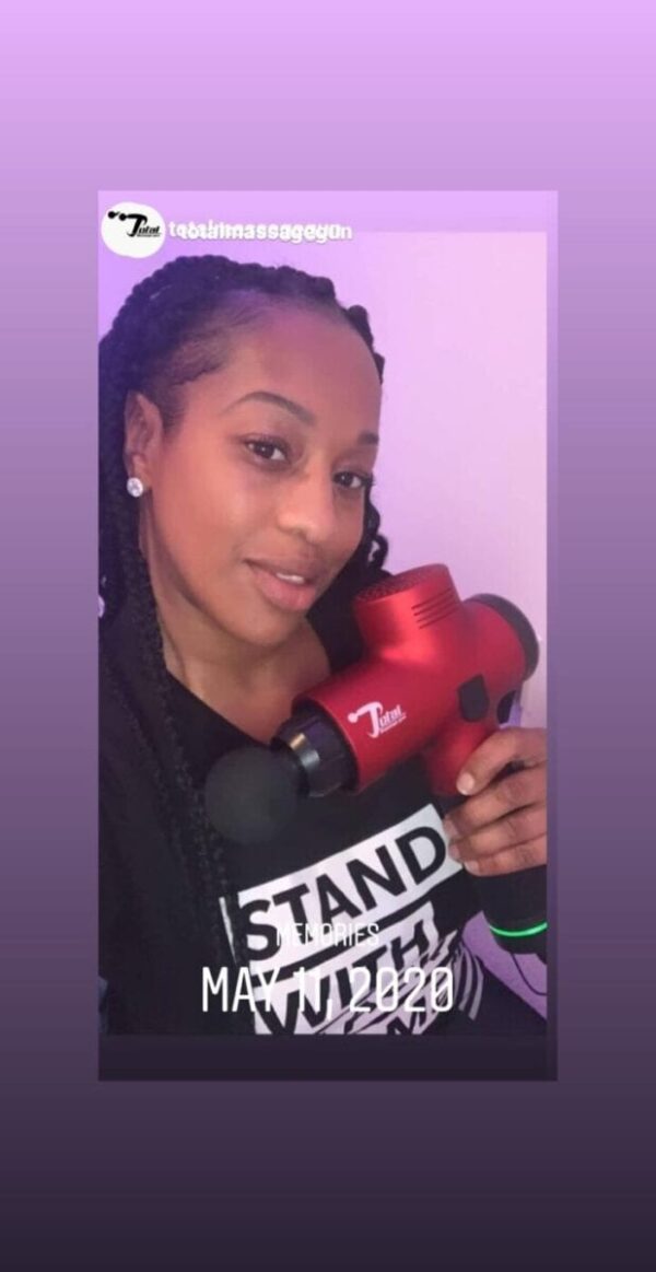 women athlete holding total massage gun