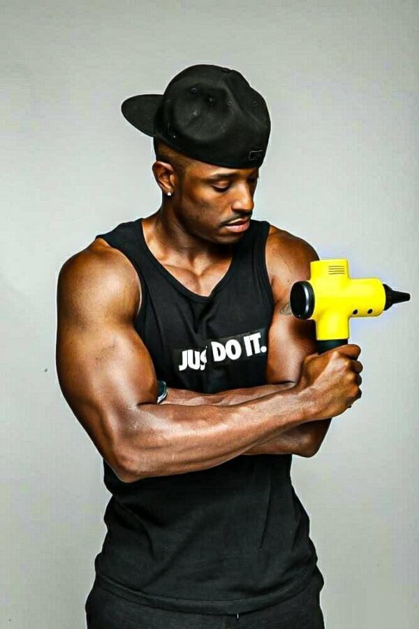 athlete holding the total massage gun