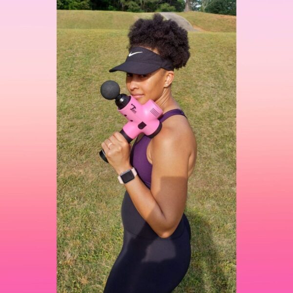 women athlete holding total massage gun