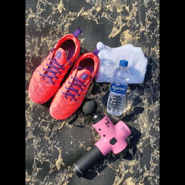 total massage gun with shoes and water bottle